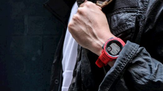 man with red garmin watch on his hand