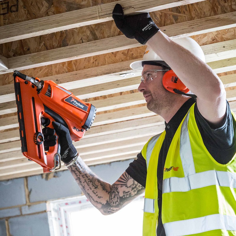 carpenter working with farming nailer