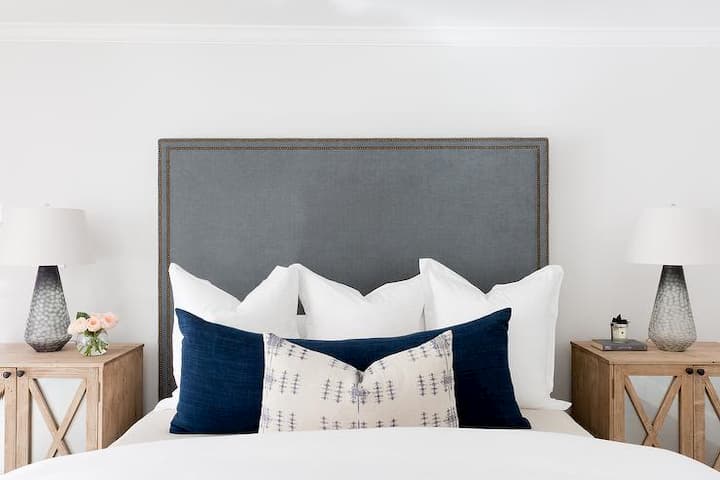 bedroom with white bedding and decorative large pillows