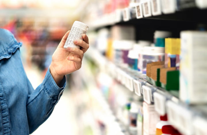 holding-medication-bottle-in-drugstore