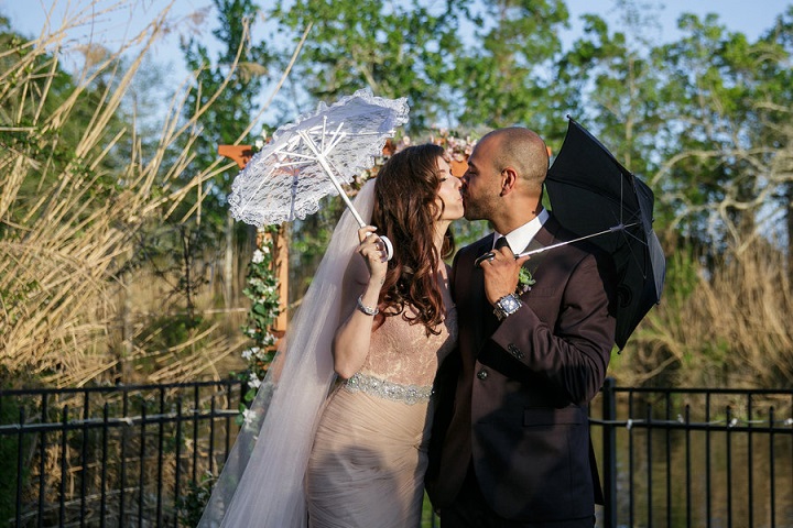 Bride and groom with wedding umbrellas