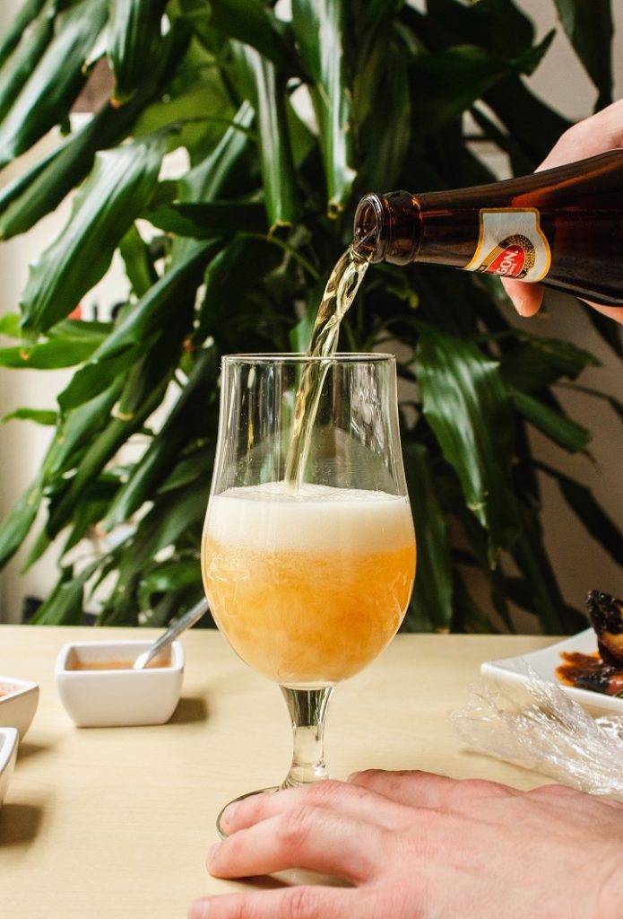 a beer being poured into a glass