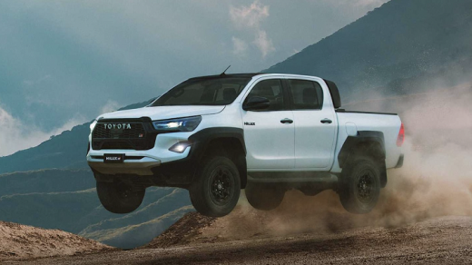 white toyota hilux captured mid air on an off-road