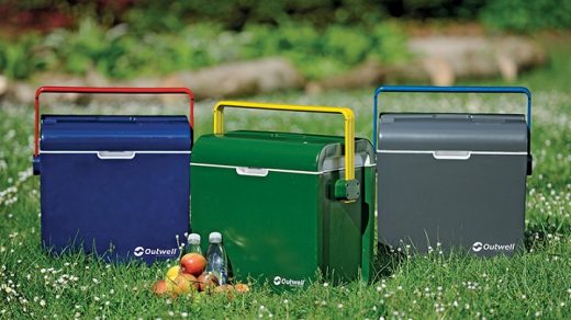 three ice cooler boxes on a grass