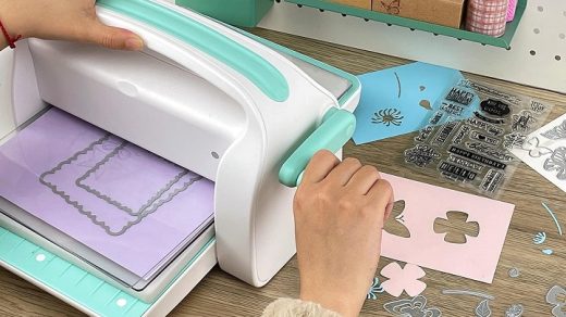 woman using die cutting machine for crafts